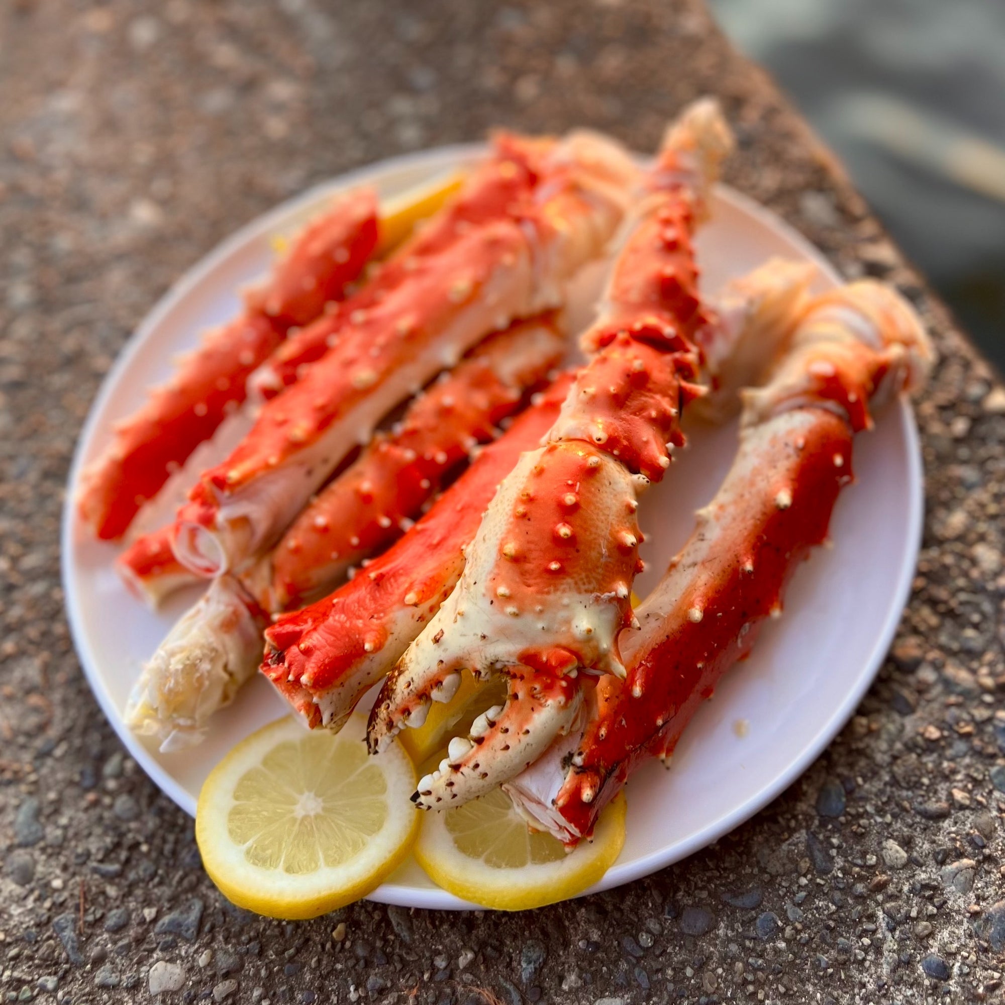 Crab legs on a plate with lemon slices