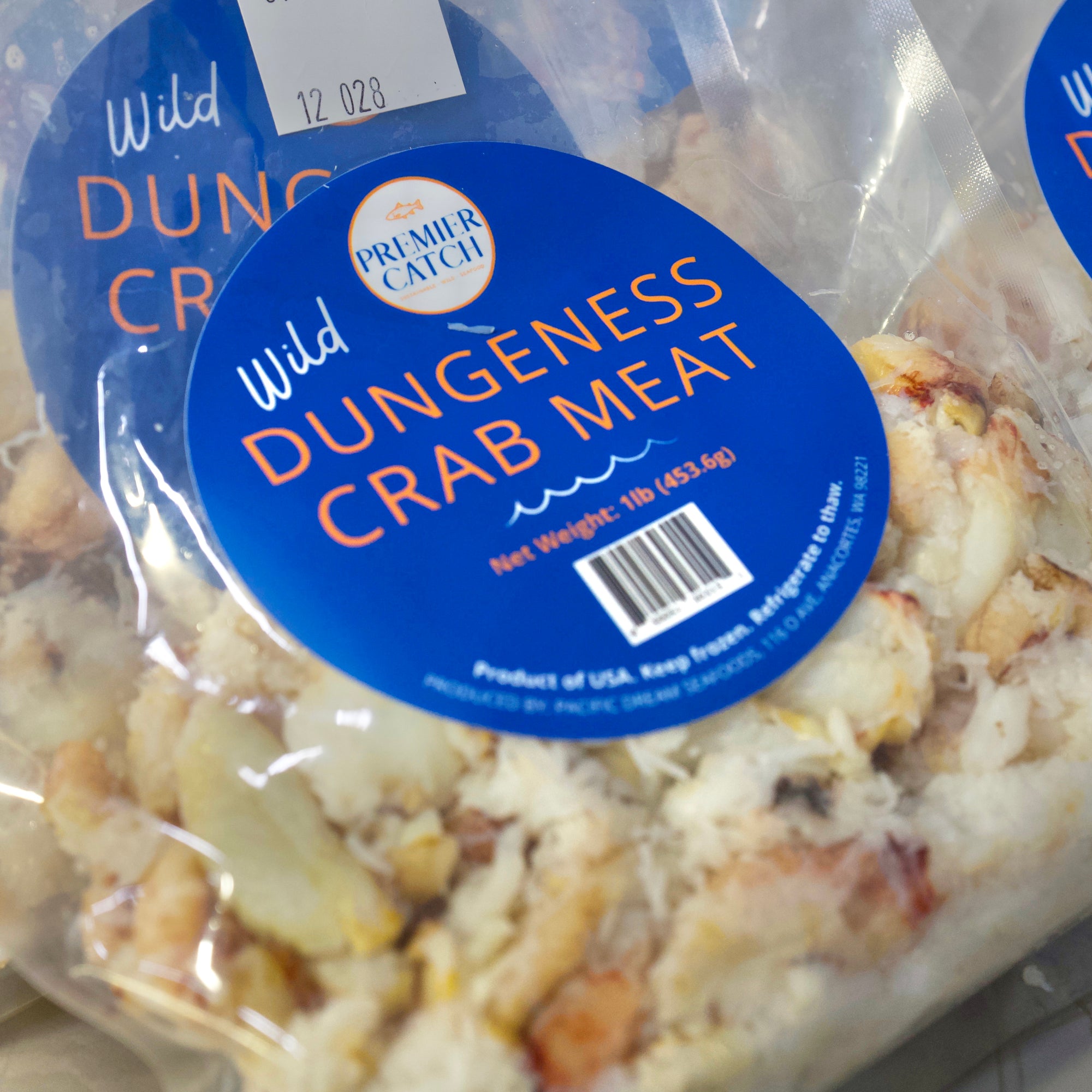 Wild caught Dungeness crab meat pieces in a frozen package from Premier Catch.