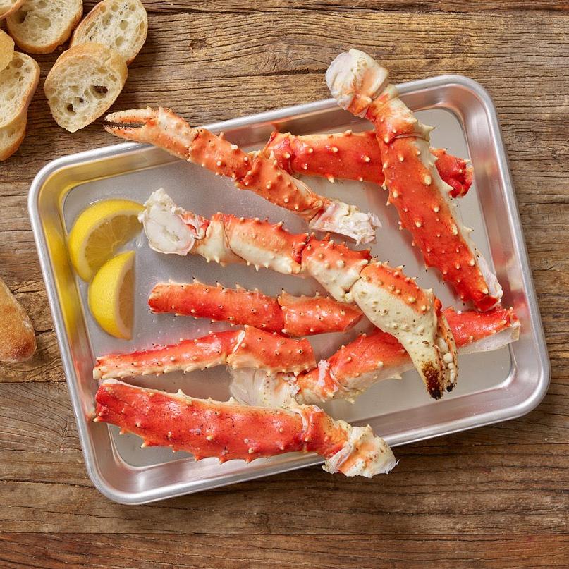 Alaskan red king crab legs served with bread and lemons