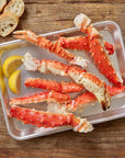 Alaskan red king crab legs served with bread and lemons