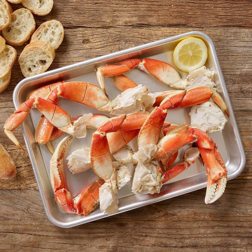 dungeness crab legs served with bread and lemon