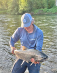 PC Trucker Hat with man carrying caught king salmon