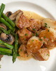 Weathervane scallop dish served on a plate with vegetables