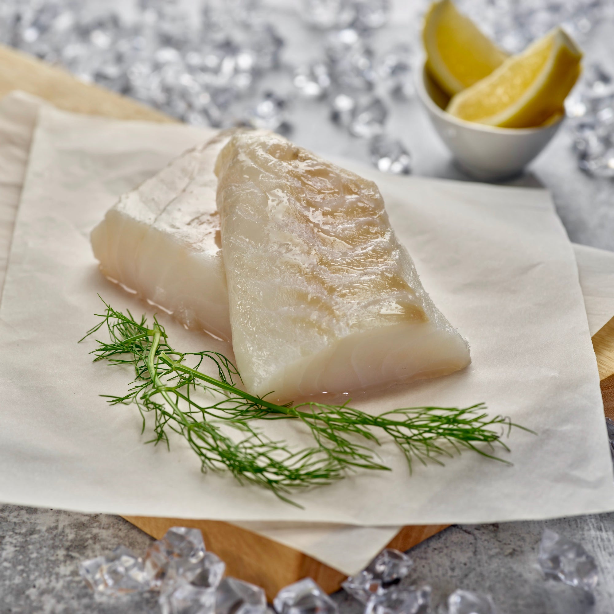 Wild cod on a wooden platter before cooking